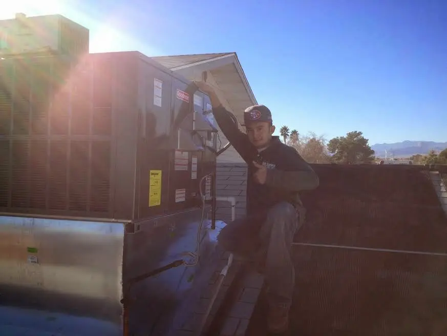 HVAC technician performing AC Tune-Up on a rooftop unit in Swoyersville